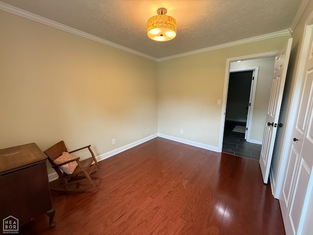 1354 Wiley Dr, Piggott, AR 72454 - unfurnished room featuring dark wood finished floors, crown molding, and a textured ceiling