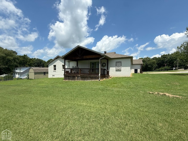 1354 Wiley Dr, Piggott, AR 72454 - rear view of house featuring a yard and brick siding