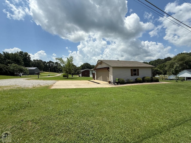 1354 Wiley Dr, Piggott, AR 72454 - view of property exterior featuring a garage, an outbuilding, and a yard