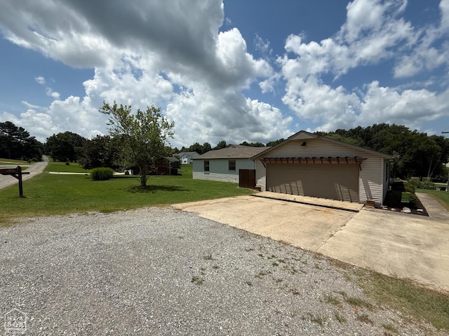 1354 Wiley Dr, Piggott, AR 72454 - ranch-style house with a front lawn, a garage, an outdoor structure, and driveway
