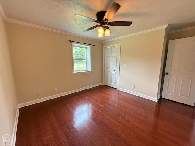 1354 Wiley Dr, Piggott, AR 72454 - unfurnished bedroom with dark wood-style flooring, crown molding, a ceiling fan, a textured ceiling, and a closet