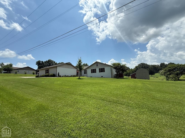1354 Wiley Dr, Piggott, AR 72454 - view of green lawn with an outdoor structure