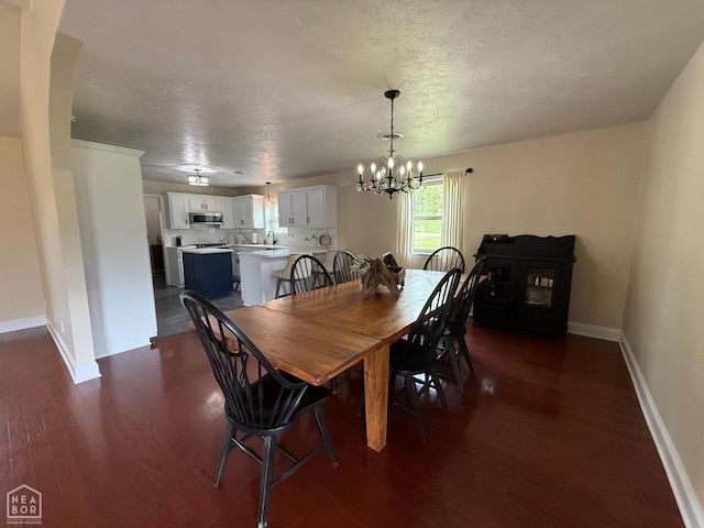 1354 Wiley Dr, Piggott, AR 72454 - dining space featuring dark wood-type flooring and a chandelier