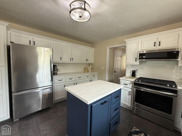 1354 Wiley Dr, Piggott, AR 72454 - kitchen featuring appliances with stainless steel finishes, blue cabinetry, and white cabinets
