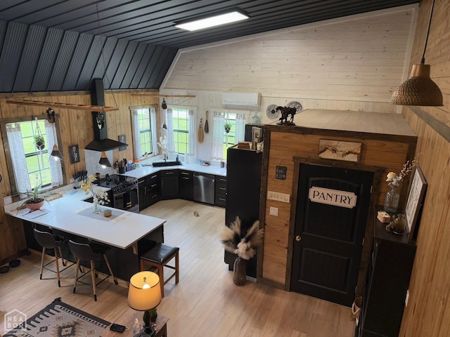 2052 Central Blvd, Bull Shoals, AR 72619 - kitchen with black gas range, wood walls, light wood-type flooring, stainless steel dishwasher, and a desk