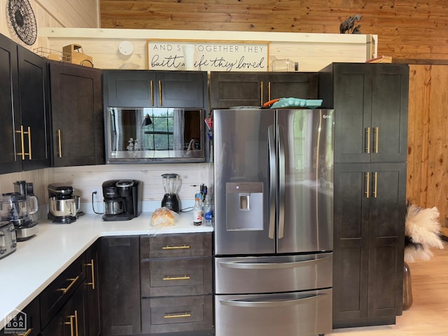 2052 Central Blvd, Bull Shoals, AR 72619 - kitchen with stainless steel appliances, wood walls, light countertops, and light wood finished floors