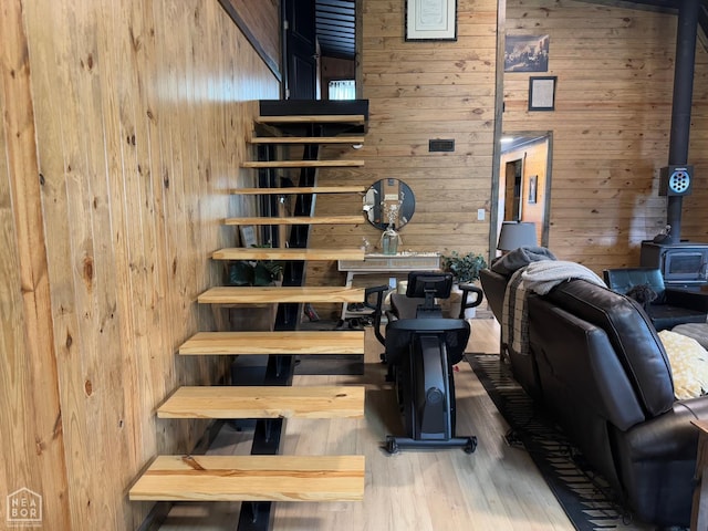 2052 Central Blvd, Bull Shoals, AR 72619 - stairway featuring a wood stove, wood walls, and wood finished floors