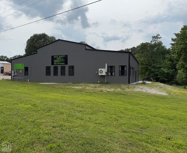 2052 Central Blvd, Bull Shoals, AR 72619 - view of side of home with a pole building, a yard, and an outbuilding