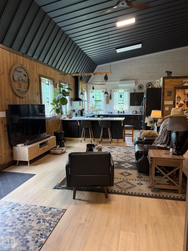 2052 Central Blvd, Bull Shoals, AR 72619 - living room with wood walls, light wood-type flooring, and vaulted ceiling