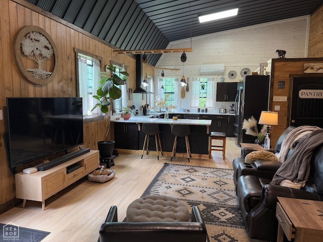 2052 Central Blvd, Bull Shoals, AR 72619 - living room with wooden walls, light wood-type flooring, vaulted ceiling, and a wall mounted AC
