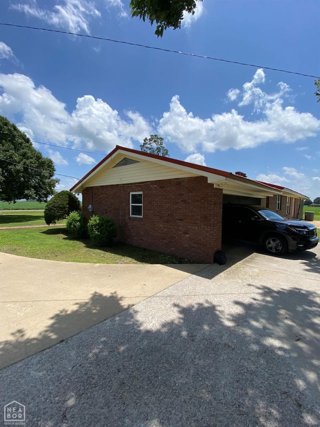 3969 NE State Highway 239, Blytheville, AR 72315 - view of home's exterior with brick siding, driveway, and a garage