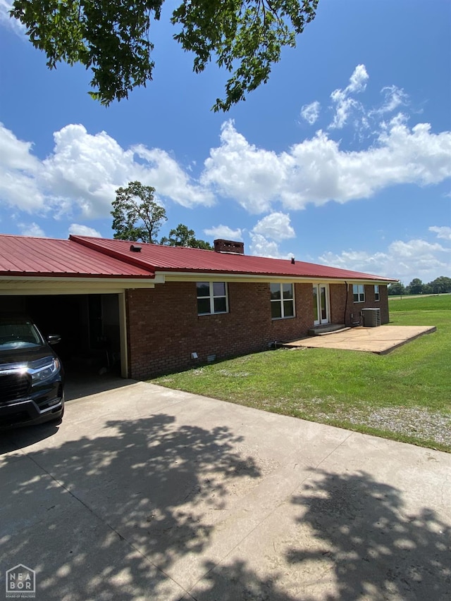 3969 NE State Highway 239, Blytheville, AR 72315 - view of front facade with brick siding, concrete driveway, a front lawn, and an attached garage