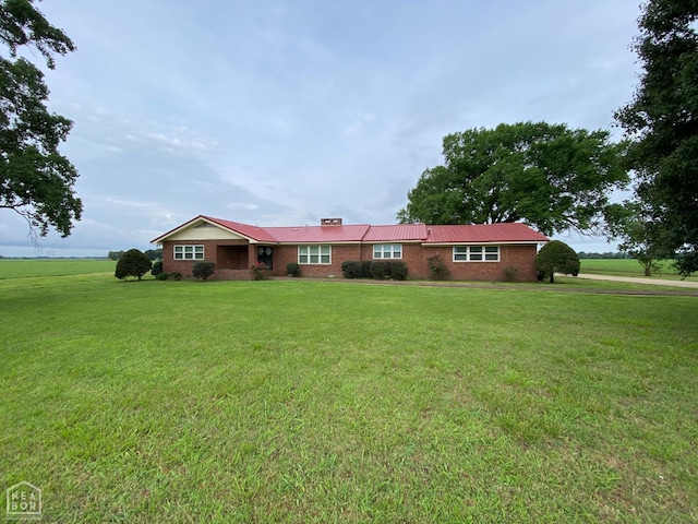 3969 NE State Highway 239, Blytheville, AR 72315 - ranch-style home featuring brick siding, a chimney, and a front yard