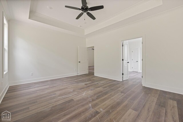 3428 Hudson Dr, Jonesboro, AR 72405 - spare room featuring wood finished floors, baseboards, a ceiling fan, and a raised ceiling