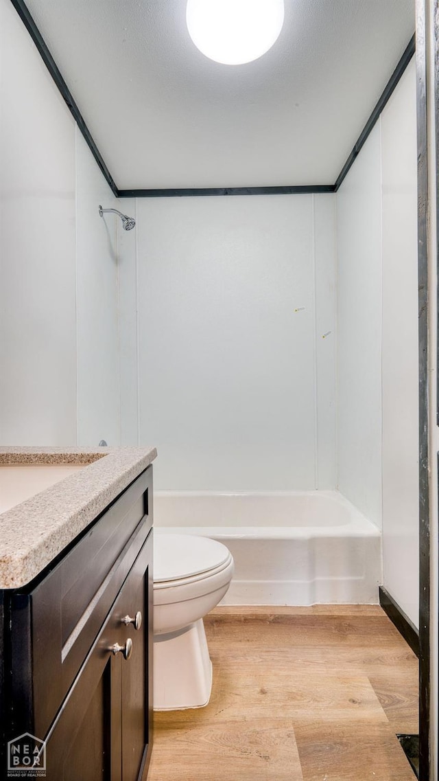 1205 Sims Ave, Jonesboro, AR 72401 - full bathroom featuring wood finished floors, toilet, shower / bathtub combination, and vanity