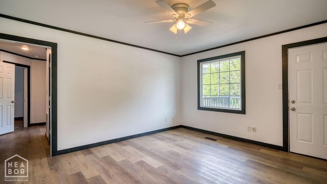 1205 Sims Ave, Jonesboro, AR 72401 - unfurnished room with crown molding, wood finished floors, ceiling fan, and baseboards