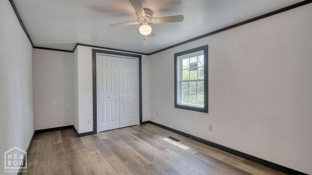 1205 Sims Ave, Jonesboro, AR 72401 - unfurnished bedroom featuring crown molding, baseboards, light wood-type flooring, a closet, and ceiling fan