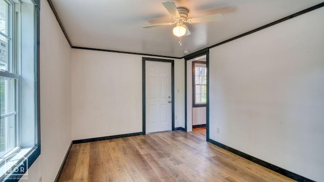 1205 Sims Ave, Jonesboro, AR 72401 - unfurnished bedroom with light wood-style flooring, baseboards, and a ceiling fan