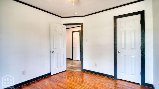 1205 Sims Ave, Jonesboro, AR 72401 - unfurnished bedroom featuring wood finished floors, baseboards, and ornamental molding