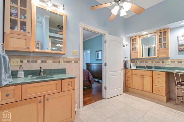full bath featuring a sink, ceiling fan, crown molding, two vanities, and tile patterned flooring