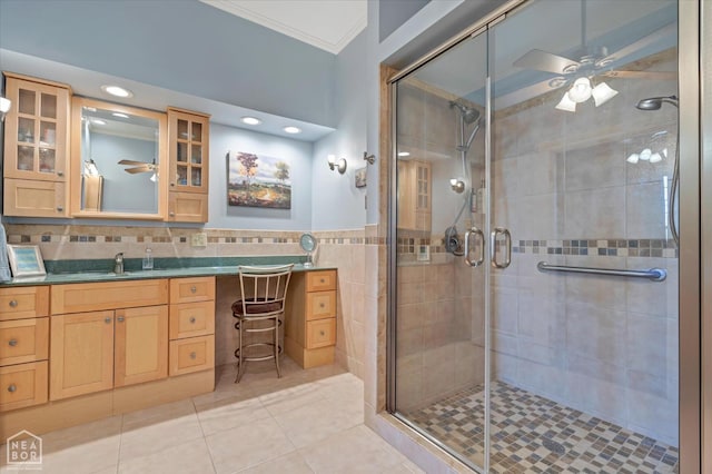 full bathroom with crown molding, ceiling fan, and a shower stall