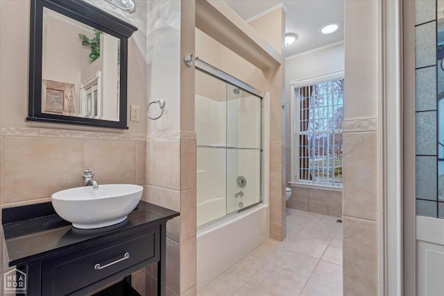 full bath featuring toilet, tile walls, tile patterned flooring, and crown molding