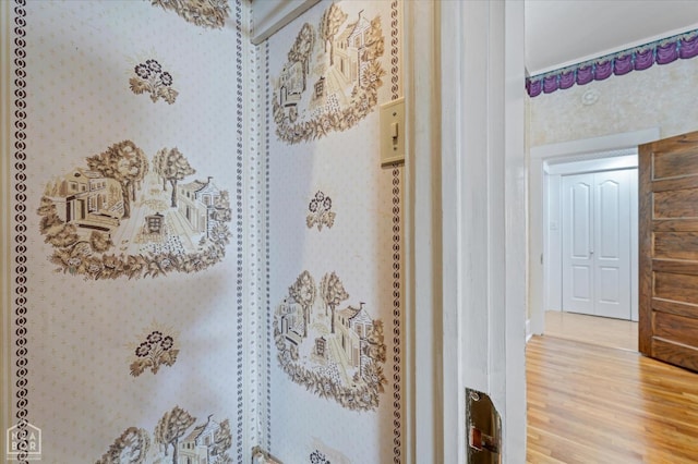 room details with wallpapered walls and wood finished floors