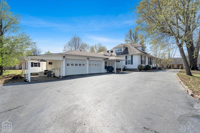 view of front of home with a garage and aphalt driveway