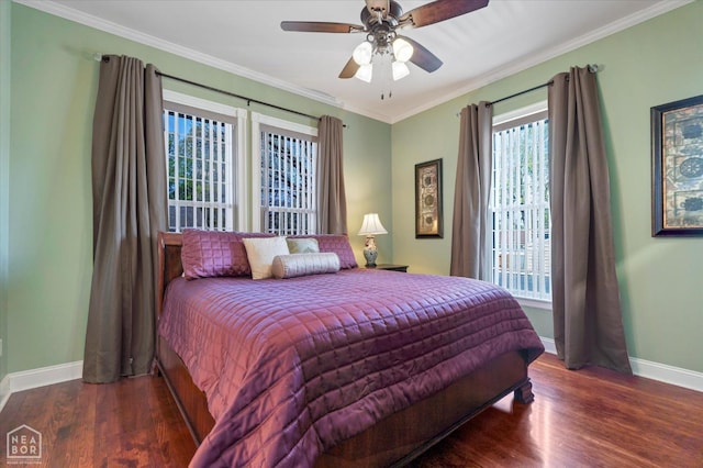 bedroom featuring crown molding, wood finished floors, baseboards, and a ceiling fan