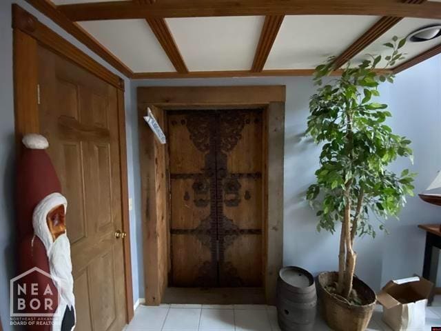 doorway with light tile patterned floors
