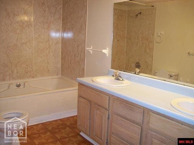 full bathroom with double vanity, shower / tub combination, and a sink