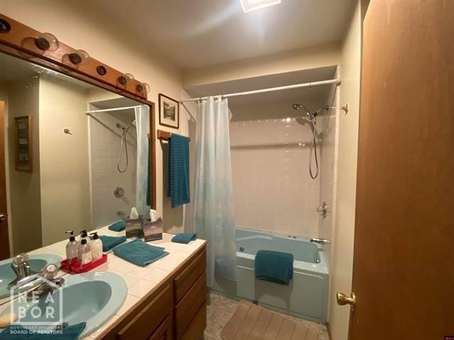 bathroom with shower / tub combo, vanity, and tile patterned flooring