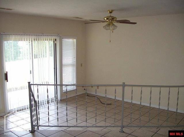 spare room with light tile patterned floors, visible vents, and ceiling fan