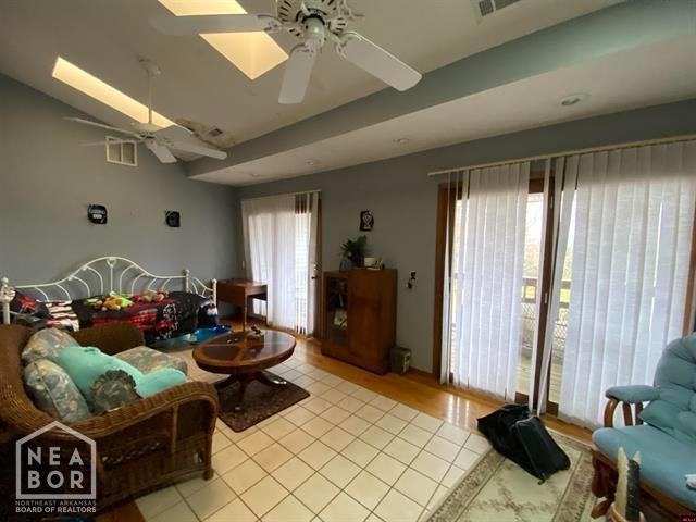 living room with visible vents, ceiling fan, and plenty of natural light