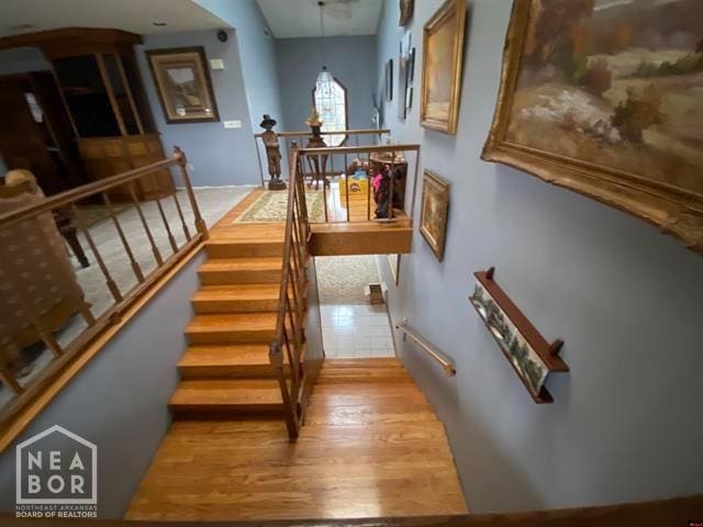stairway with wood finished floors