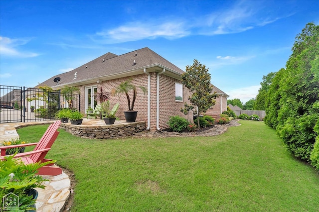 4260 Weldon Cv, Jonesboro, AR 72404 - rear view of house featuring brick siding, a patio area, and a shingled roof