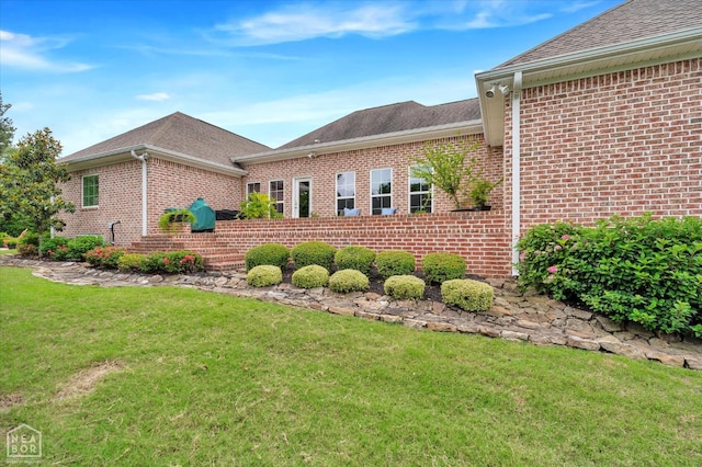 4260 Weldon Cv, Jonesboro, AR 72404 - view of side of home featuring brick siding, a lawn, and a shingled roof