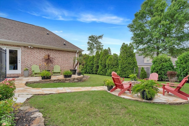 4260 Weldon Cv, Jonesboro, AR 72404 - view of grassy yard featuring a patio area and a fire pit