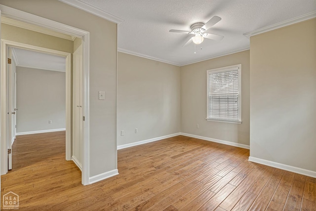 unfurnished room with light wood-style flooring, ornamental molding, and ceiling fan