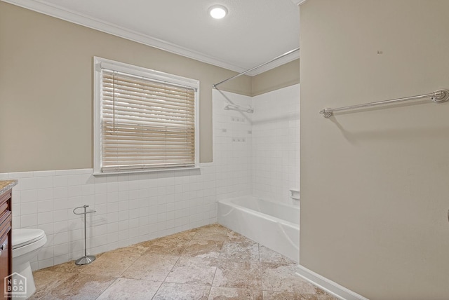 full bath featuring tile walls, toilet, crown molding, bathtub / shower combination, and vanity