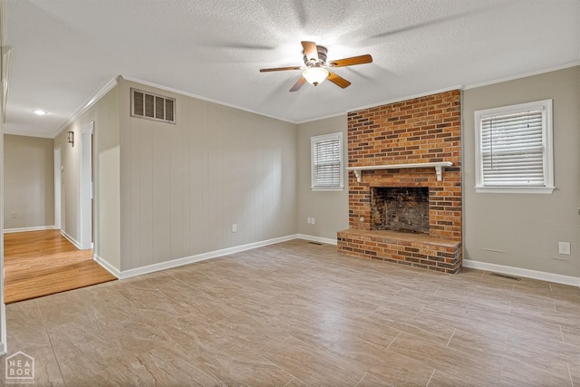 unfurnished living room with ornamental molding, visible vents, ceiling fan, and plenty of natural light