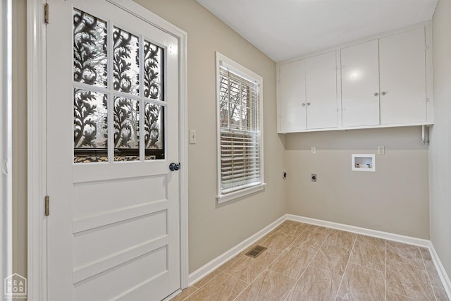 clothes washing area featuring visible vents, baseboards, hookup for an electric dryer, cabinet space, and hookup for a washing machine