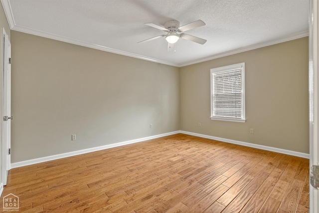 spare room featuring ceiling fan, a textured ceiling, ornamental molding, light wood finished floors, and baseboards