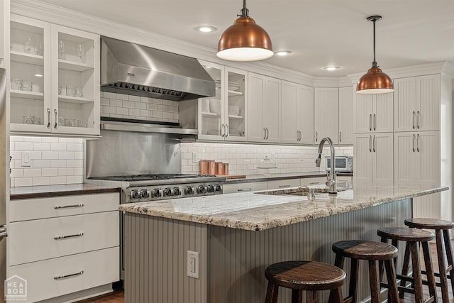 803 Fairway Dr, Jonesboro, AR 72401 - kitchen featuring white cabinets, decorative backsplash, exhaust hood, and light stone counters
