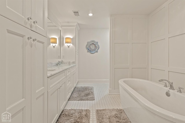 803 Fairway Dr, Jonesboro, AR 72401 - full bathroom featuring a freestanding tub, tile patterned flooring, visible vents, a sink, and double vanity