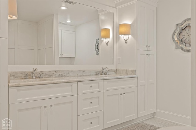 803 Fairway Dr, Jonesboro, AR 72401 - bathroom with tile patterned flooring, double vanity, baseboards, and a sink