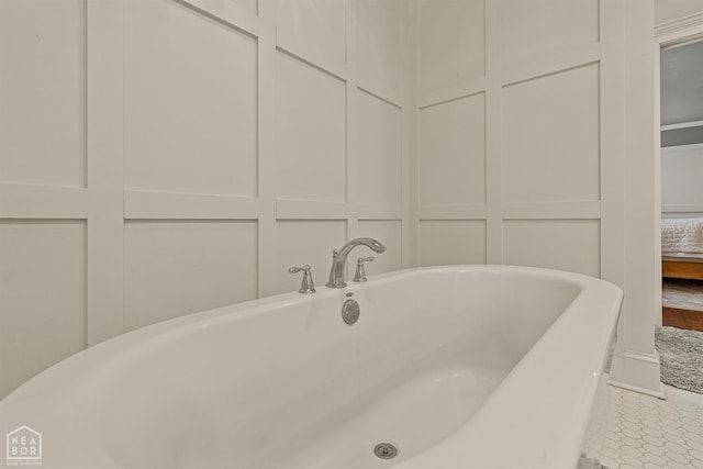 803 Fairway Dr, Jonesboro, AR 72401 - bathroom featuring a freestanding bath and a decorative wall