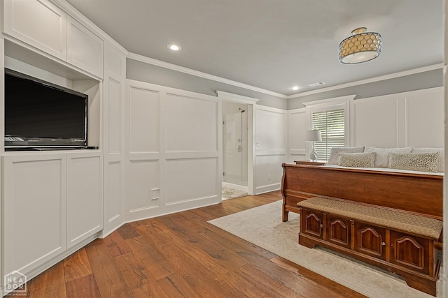 803 Fairway Dr, Jonesboro, AR 72401 - bedroom with recessed lighting, crown molding, visible vents, a decorative wall, and wood finished floors