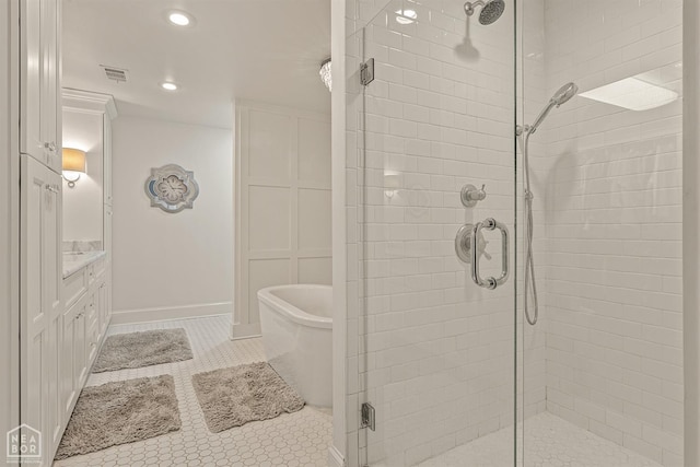 803 Fairway Dr, Jonesboro, AR 72401 - full bathroom featuring a tub, recessed lighting, vanity, tile patterned floors, and a stall shower