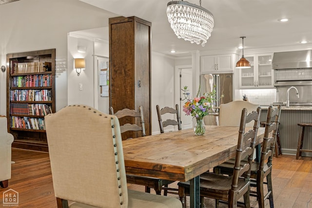 803 Fairway Dr, Jonesboro, AR 72401 - dining room with recessed lighting, light wood-style floors, and an inviting chandelier